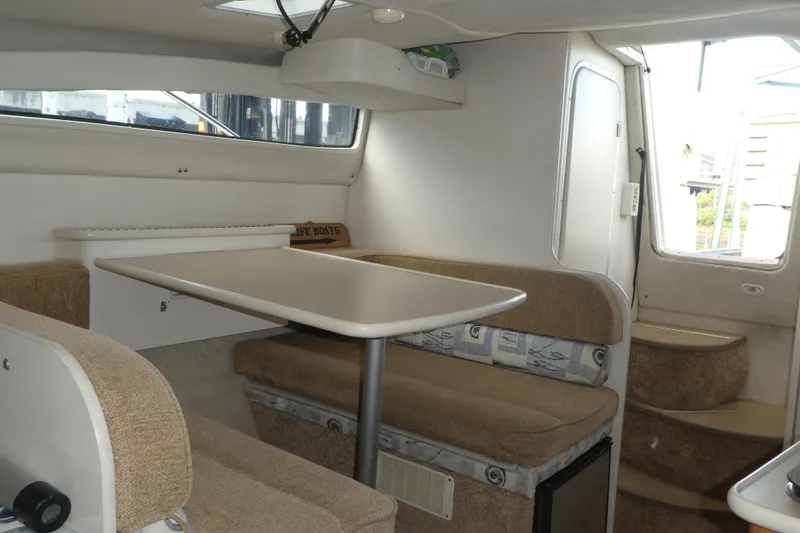 Slide: The Image of Interior of 2002 Bayliner 2855 Ciera boat with dining area and seating. - 5