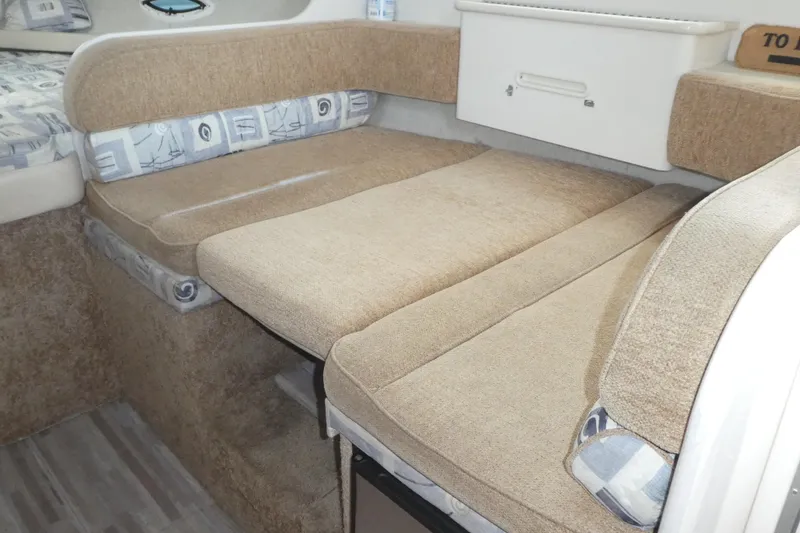 Slide: The Image of 2002 Bayliner 2855 Ciera interior with beige seating and patterned cushions. - 6