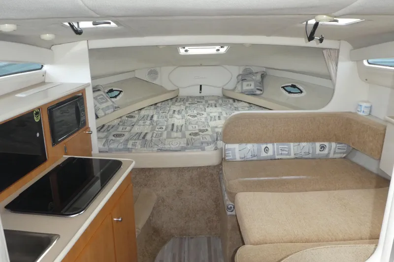 Slide: The Image of Interior of a 2002 Bayliner 2855 Ciera boat with cozy seating and sleeping area. - 7