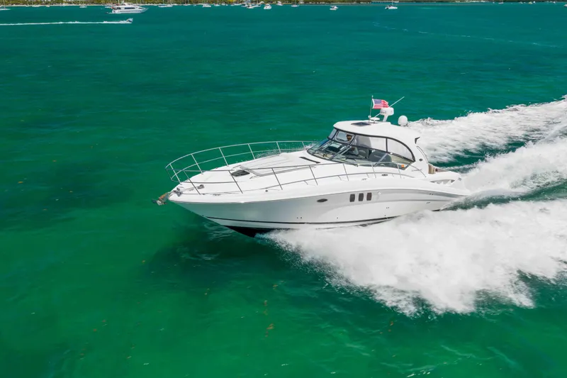 Slide: The Image of 2009 Sea Ray 40 Sundancer cruising on vibrant turquoise waters. - 13