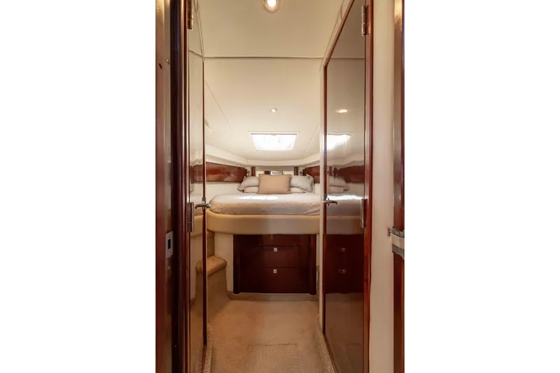 Slide: The Image of Luxurious cabin interior of 2009 Sea Ray 40 Sundancer yacht, featuring elegant wood finishes. - 16