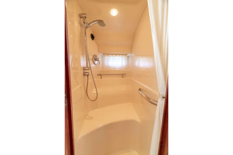 Slide: The Image of Shower area in 2009 Sea Ray 40 Sundancer yacht, featuring modern fixtures and curtain. - 17