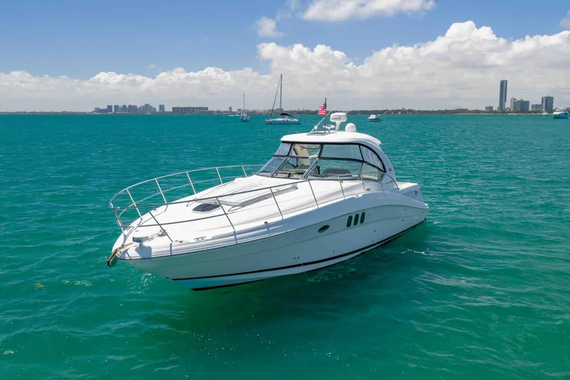 Slide: The Image of 2009 Sea Ray 40 Sundancer yacht cruising on turquoise waters under a clear sky. - 2