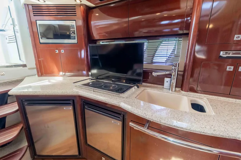 Slide: The Image of Luxurious galley in 2009 Sea Ray 40 Sundancer yacht with modern appliances and sleek design. - 25