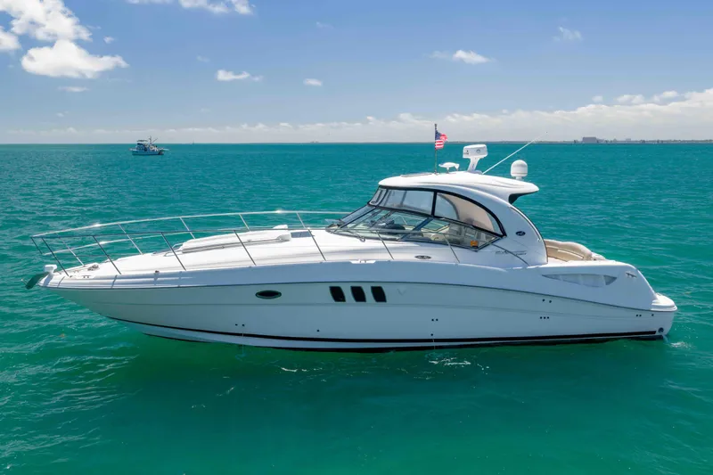 Slide: The Image of 2009 Sea Ray 40 Sundancer yacht cruising on clear blue ocean waters. - 3