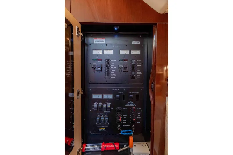 Slide: The Image of Electrical panel inside 2009 Sea Ray 40 Sundancer yacht, featuring various switches and meters. - 30