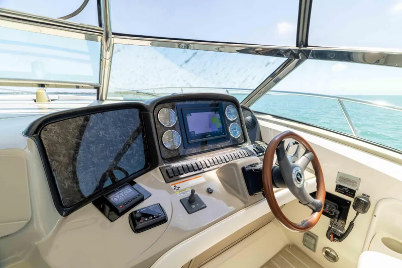 Slide: The Image of Helm of 2009 Sea Ray 40 Sundancer with navigation controls and ocean view. - 32