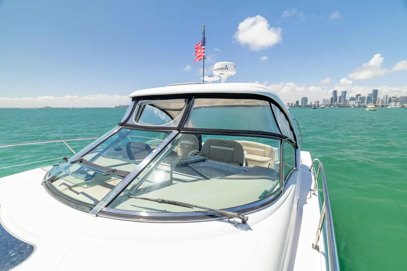 Slide: The Image of 2009 Sea Ray 40 Sundancer yacht cruising on turquoise waters with city skyline backdrop. - 35