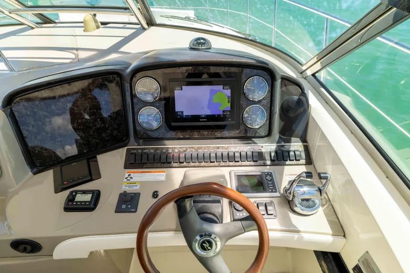Slide: The Image of Cockpit view of 2009 Sea Ray 40 Sundancer with navigation controls and steering wheel. - 36