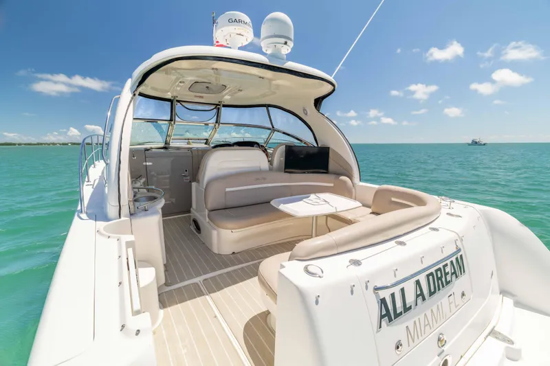Slide: The Image of 2009 Sea Ray 40 Sundancer yacht on turquoise water, featuring spacious seating and modern amenities. - 40