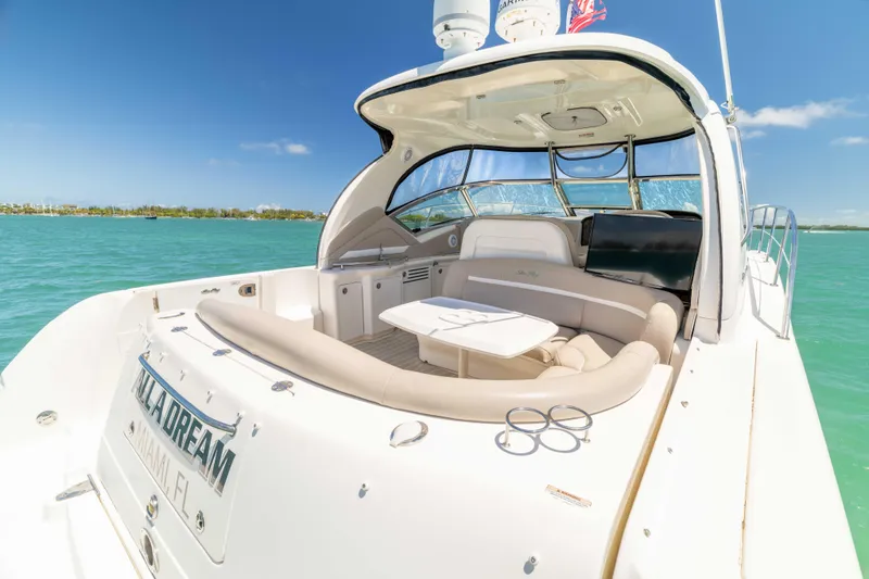 Slide: The Image of 2009 Sea Ray 40 Sundancer yacht with spacious deck, cruising on turquoise waters. - 42