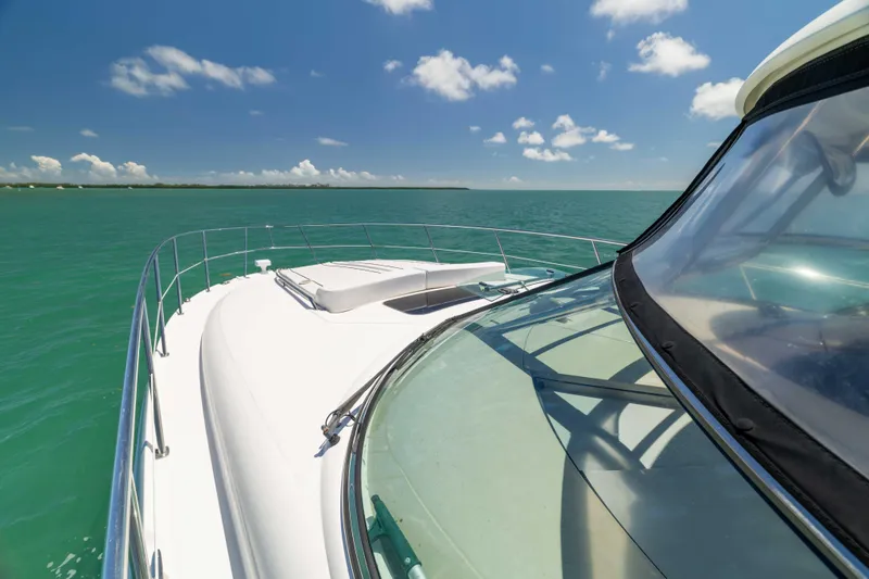 Slide: The Image of 2009 Sea Ray 40 Sundancer yacht cruising on turquoise waters under a clear blue sky. - 44
