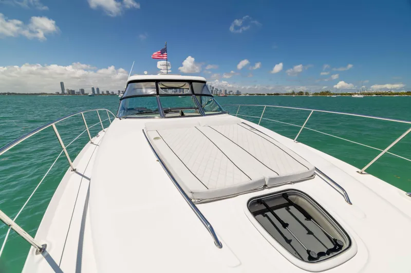 Slide: The Image of 2009 Sea Ray 40 Sundancer yacht cruising on turquoise waters under a clear blue sky. - 45