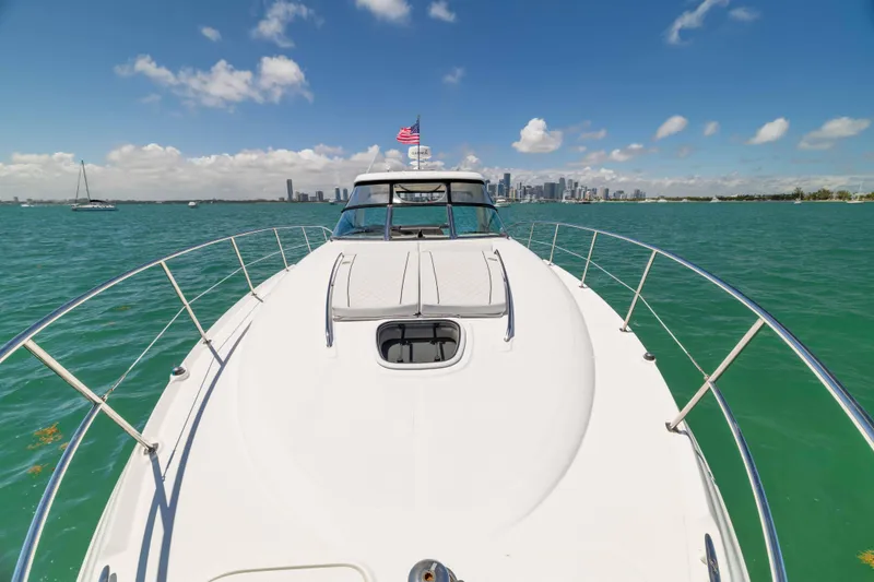 Slide: The Image of 2009 Sea Ray 40 Sundancer yacht cruising on turquoise waters under a clear blue sky. - 46