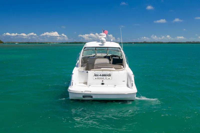 Slide: The Image of 2009 Sea Ray 40 Sundancer yacht cruising in turquoise waters under a clear blue sky. - 5