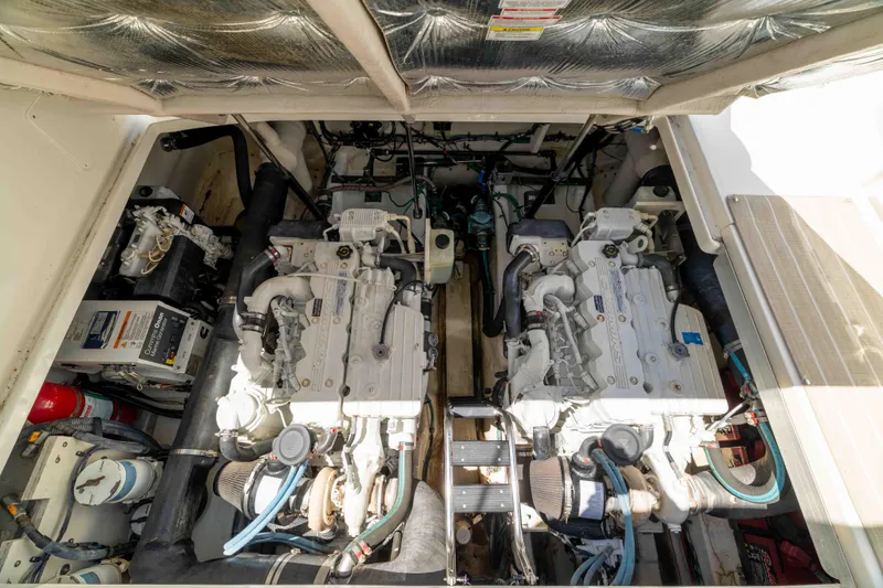 Slide: The Image of Engine room of a 2009 Sea Ray 40 Sundancer yacht, showcasing dual engines. - 51