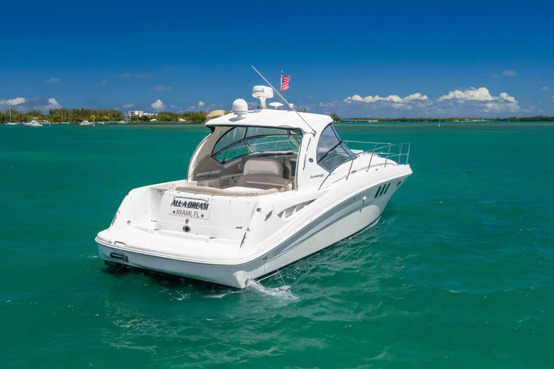 Slide: The Image of 2009 Sea Ray 40 Sundancer yacht cruising in turquoise waters under clear blue skies. - 6