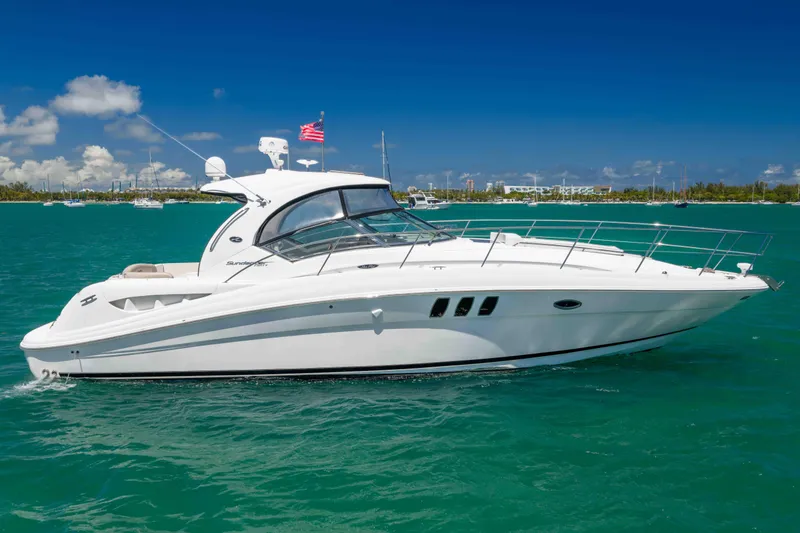 Slide: The Image of 2009 Sea Ray 40 Sundancer yacht cruising on turquoise waters under a clear blue sky. - 7
