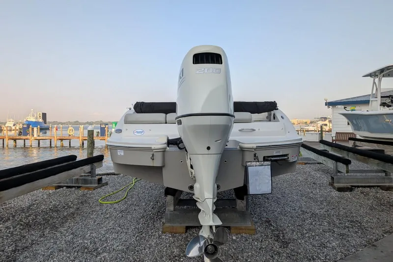 Slide: The Image of 2018 Starcraft MDX 211 O/B boat with outboard motor, docked by the waterfront. - 3