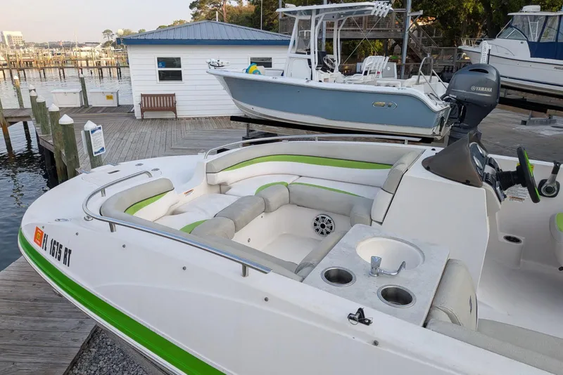 Slide: The Image of 2018 Starcraft MDX 211 O/B boat docked, featuring spacious seating and modern amenities. - 5
