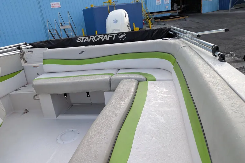 Slide: The Image of 2018 Starcraft MDX 211 O/B boat interior with green and white seating. - 9