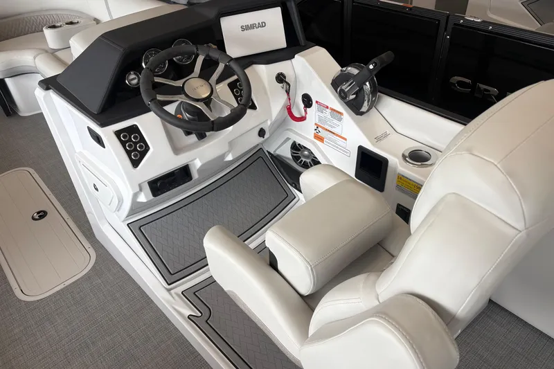 Slide: The Image of Interior of 2026 Crest 230 SLRC Caribbean boat, featuring modern steering and controls. - 3