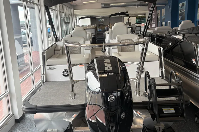 Slide: The Image of 2026 Crest 230 SLRC Caribbean boat with powerful outboard motor in showroom display. - 9