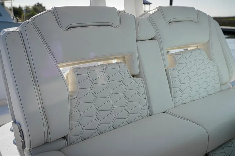 Slide: The Image of Luxurious seating on 2026 Tidewater 3100 Carolina Bay boat with hexagonal stitching design. - 11