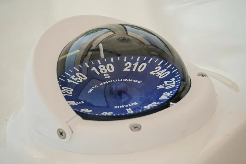 Slide: The Image of Compass on 2026 Tidewater 3100 Carolina Bay boat dashboard. - 12