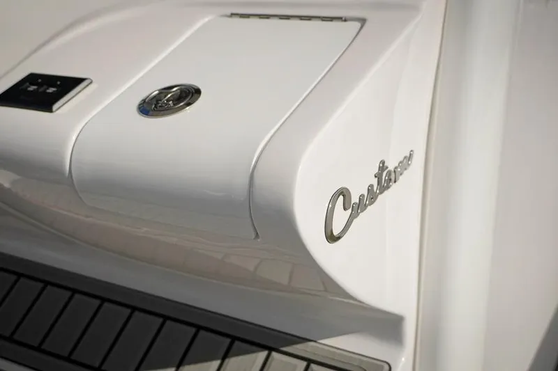 Slide: The Image of Close-up of 2026 Tidewater 3100 Carolina Bay boat with "Custom" emblem. - 14
