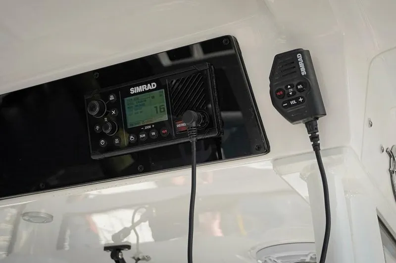 Slide: The Image of Simrad marine radio system on 2026 Tidewater 3100 Carolina Bay boat dashboard. - 15