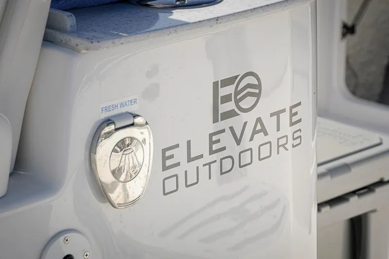 Slide: The Image of 2026 Tidewater 3100 Carolina Bay boat with "Elevate Outdoors" branding and fresh water access. - 16