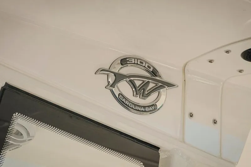 Slide: The Image of 2026 Tidewater 3100 Carolina Bay boat emblem on white surface. - 17