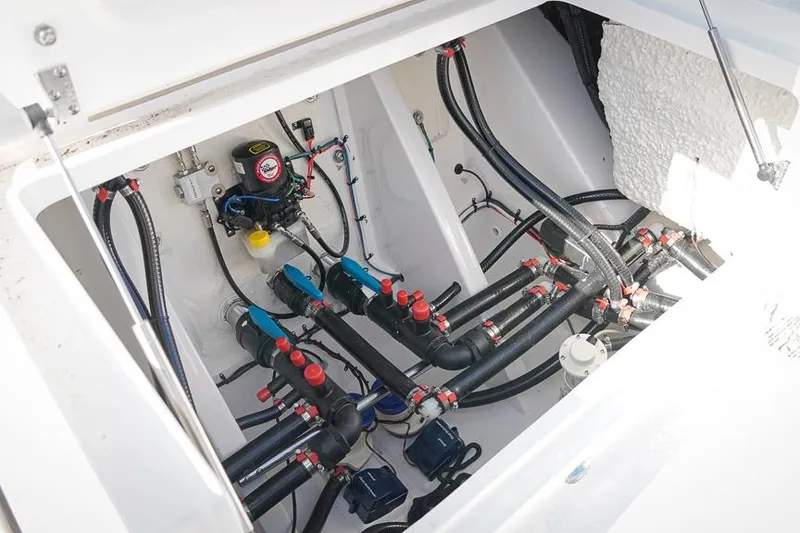 Slide: The Image of 2026 Tidewater 3100 Carolina Bay boat plumbing system with pipes and valves. - 19