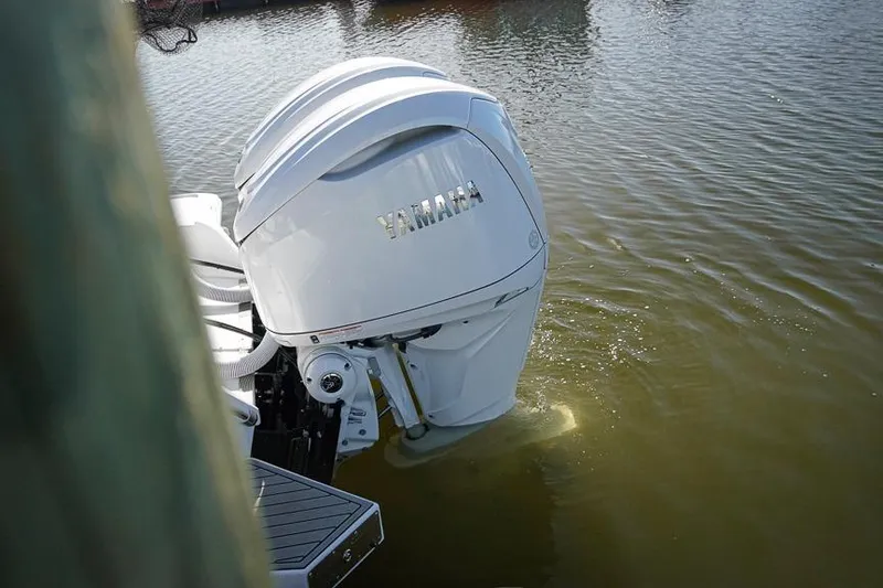 Slide: The Image of Outboard motor on 2026 Tidewater 3100 Carolina Bay boat in water. - 20
