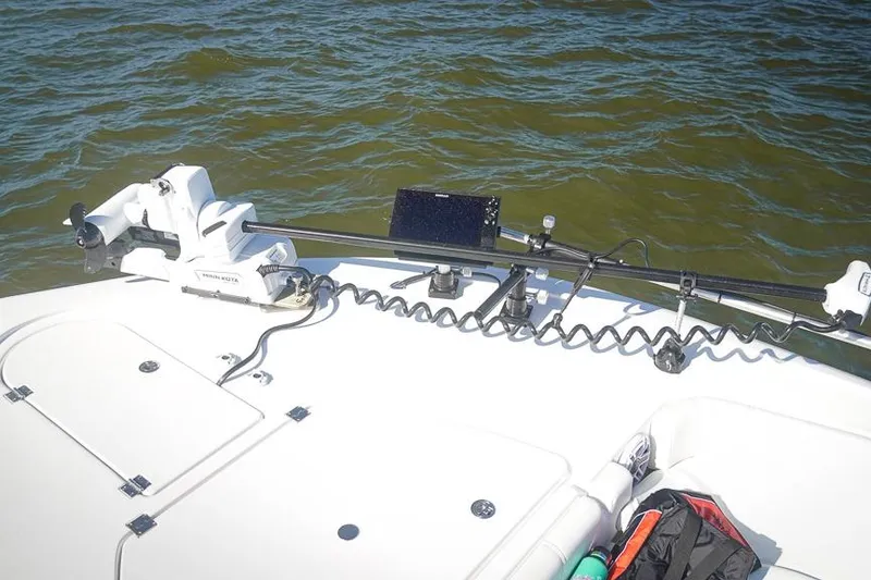 Slide: The Image of Bow of 2026 Tidewater 3100 Carolina Bay boat with trolling motor on water. - 21