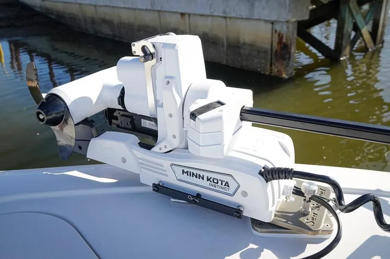 Slide: The Image of Minn Kota Instinct motor on 2026 Tidewater 3100 Carolina Bay boat, docked by water. - 23