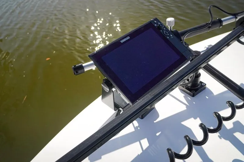 Slide: The Image of Simrad display on 2026 Tidewater 3100 Carolina Bay boat, near water surface. - 24