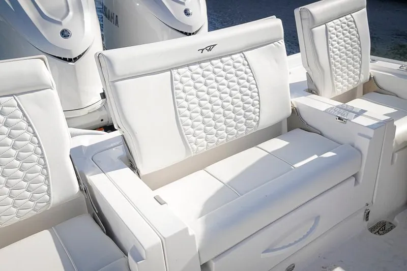 Slide: The Image of 2026 Tidewater 3100 Carolina Bay boat with luxurious white seating and Yamaha engines. - 28
