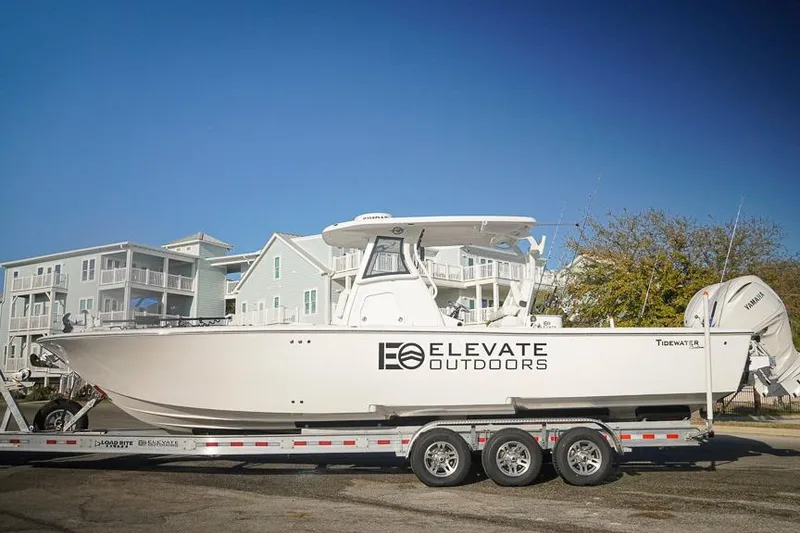 Slide: The Image of 2026 Tidewater 3100 Carolina Bay boat on trailer, featuring "Elevate Outdoors" branding. - 3