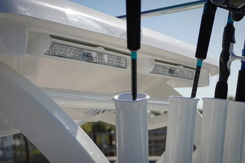 Slide: The Image of Close-up of 2026 Tidewater 3100 Carolina Bay boat's rod holders and LED lights. - 31