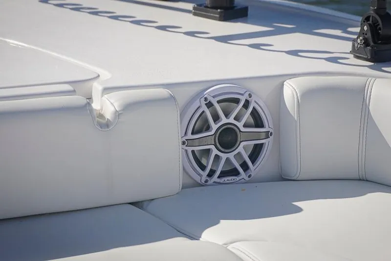 Slide: The Image of 2026 Tidewater 3100 Carolina Bay boat interior with built-in speaker and white seating. - 36