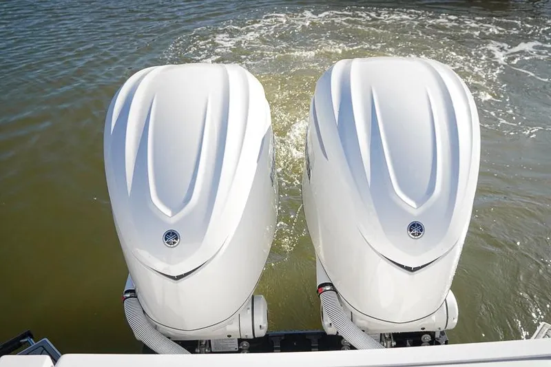 Slide: The Image of Twin outboard motors on a 2026 Tidewater 3100 Carolina Bay boat in water. - 40