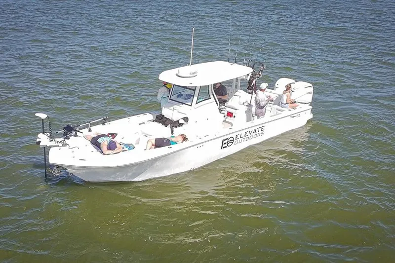 Slide: The Image of 2026 Tidewater 3100 Carolina Bay boat on water with passengers relaxing and fishing. - 42