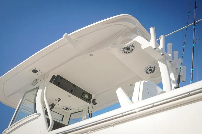 Slide: The Image of 2026 Tidewater 3100 Carolina Bay boat with T-top and fishing rod holders. - 7