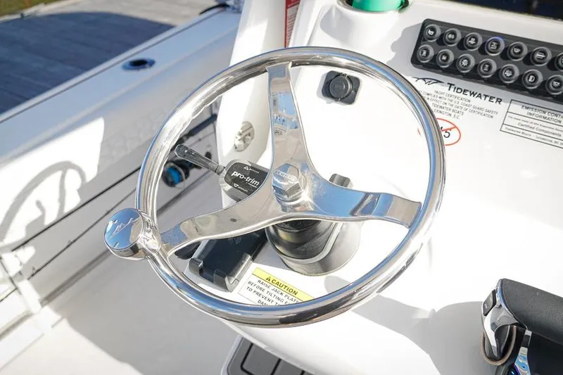 Slide: The Image of Steering wheel of 2026 Tidewater 3100 Carolina Bay boat, featuring modern controls. - 8