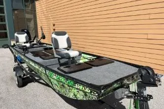 The Image of 1968 Polar Kraft Jon 1436 LW boat with dual seats, parked outdoors. - 1