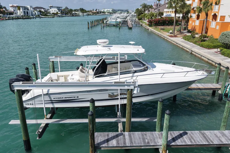 The Image of 2005 Hydra-Sports Vector 3300 VX boat docked in a scenic marina. - 0