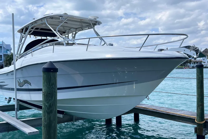Slide: The Image of 2005 Hydra-Sports Vector 3300 VX boat docked on turquoise water under cloudy sky. - 10