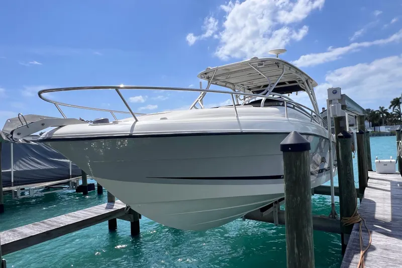 Slide: The Image of 2005 Hydra-Sports Vector 3300 VX boat docked on clear blue water under a sunny sky. - 15